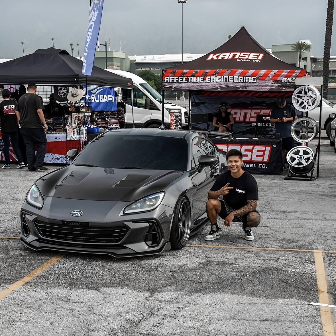 Gabriel with his Subaru at an automotive event