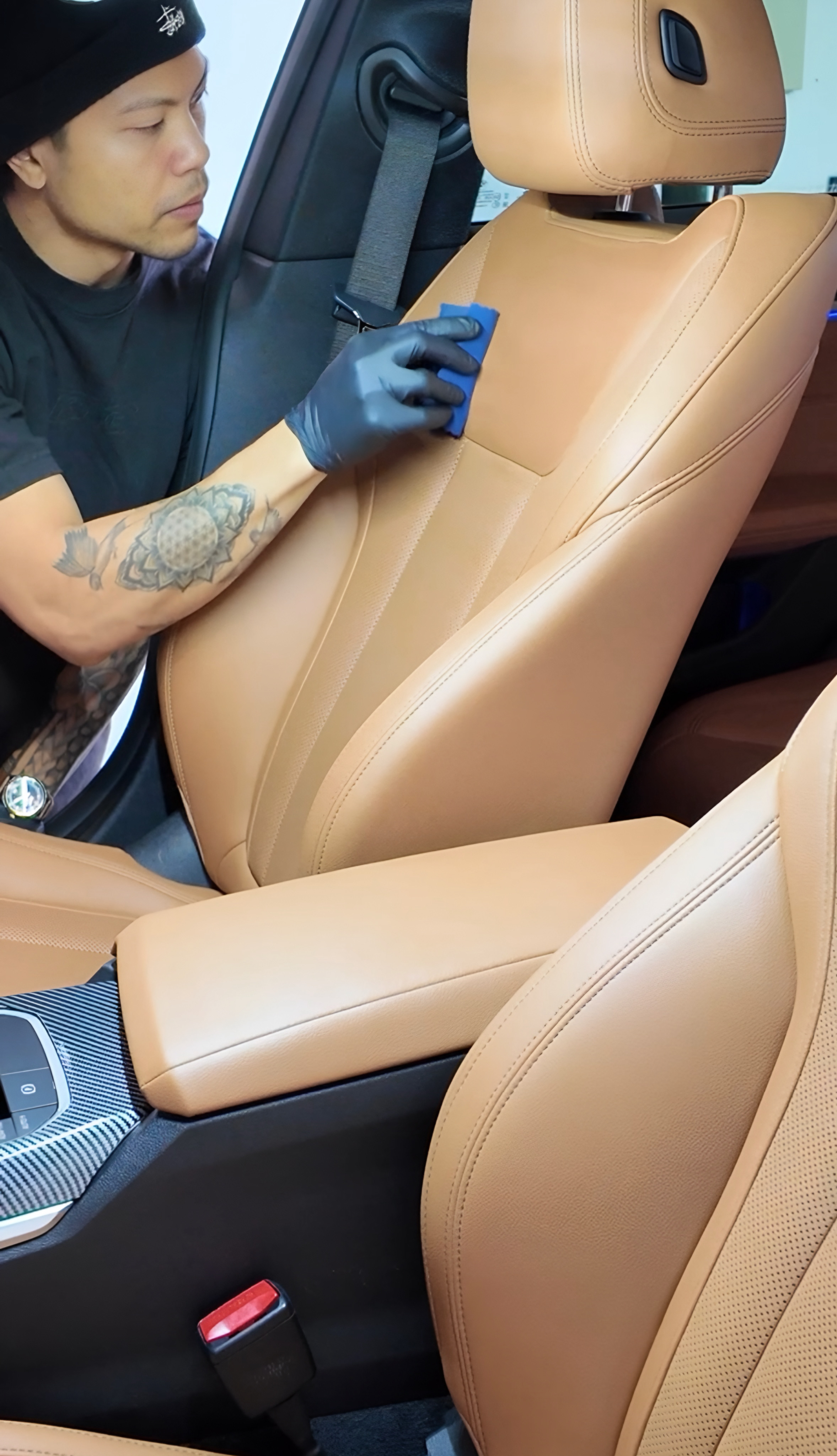 Interior ceramic coating cover image showing leather protection being applied
