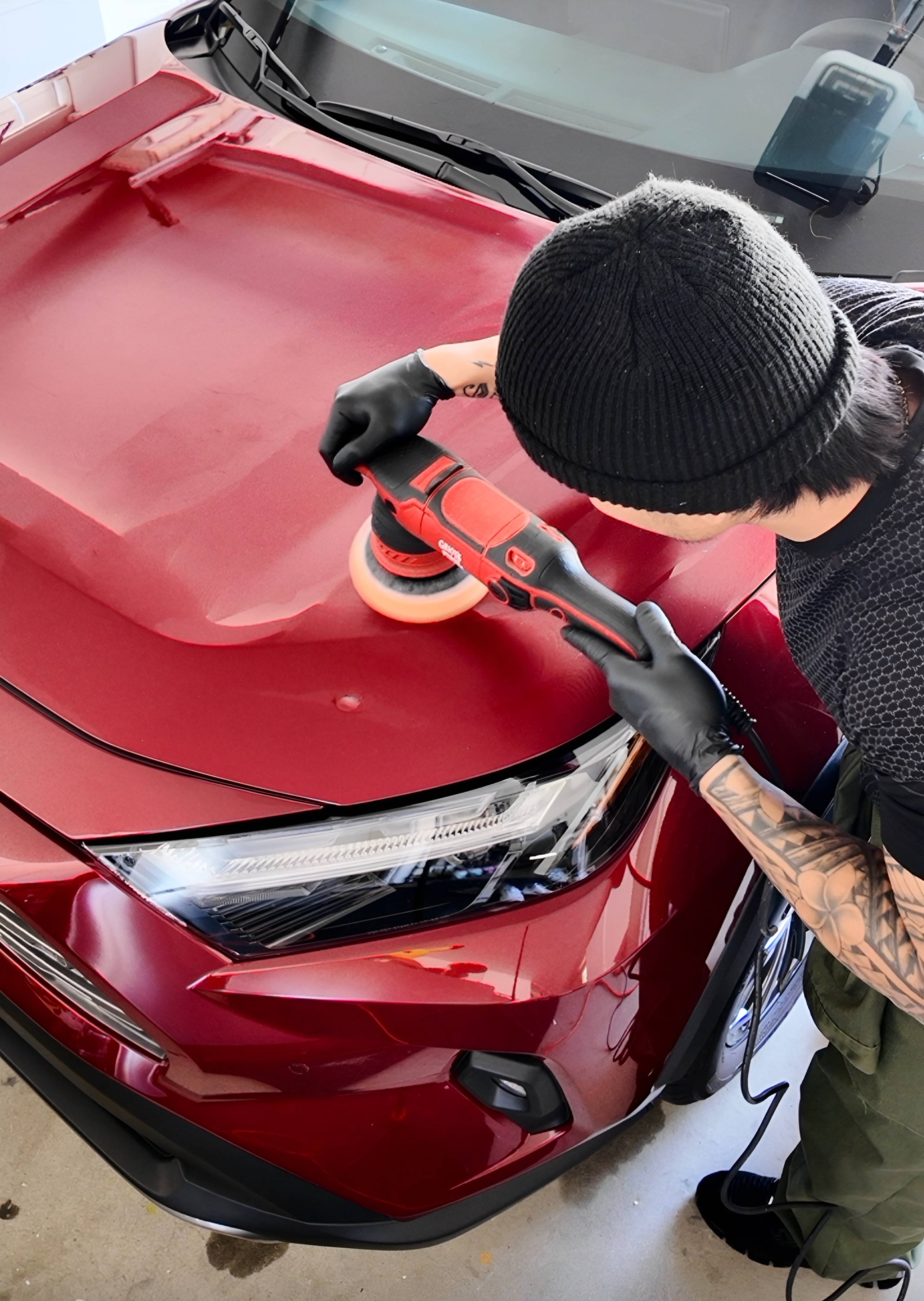 Paint correction cover image showing machine polishing on a red vehicle