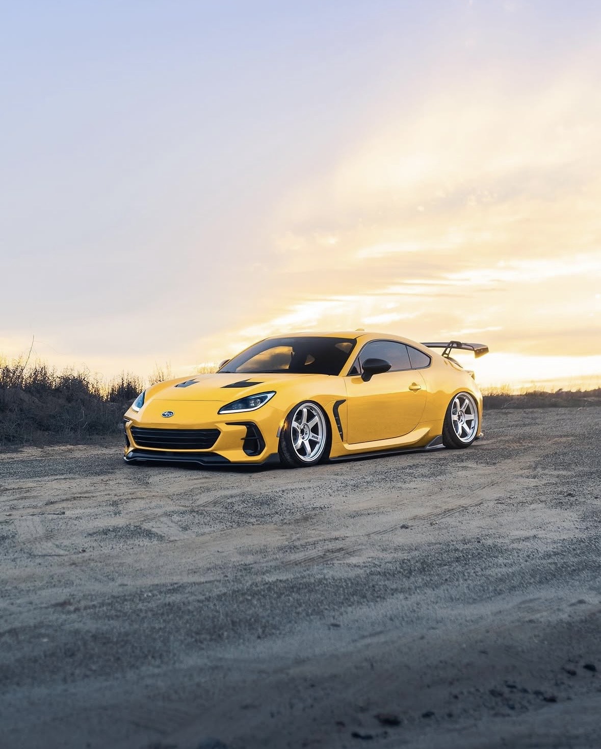 Vinyl wrap color change cover image of a yellow sports coupe